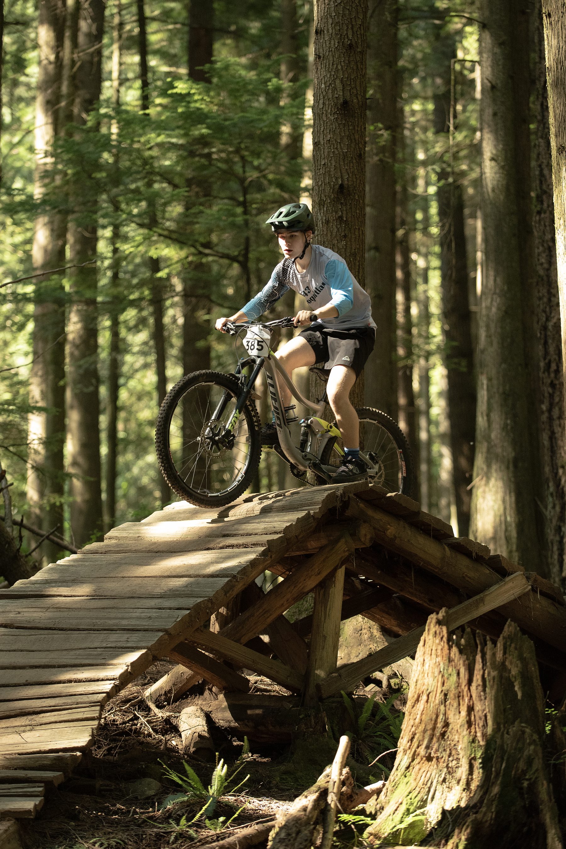 Andrew riding a wooden trail feature